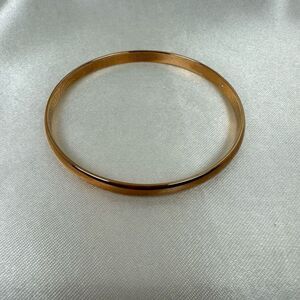 Kate Spade bronze slim stackable bangle. “Stop and Smell the Roses” engraved ins